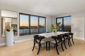 Philadelphia apartment for rent - a dining room with a table and chairs and a view of the water