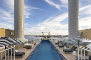 Philadelphia apartment for rent - a swimming pool on the roof of a building overlooking a body of water