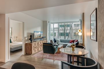 Seattle apartment for rent - A living room with a green chair and a grey sofa.