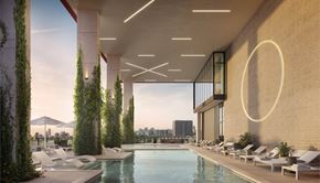 Houston apartment for rent - A modern pool area with lounge chairs and green plants.
