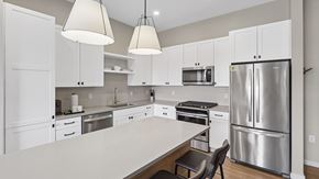 Scottsdale apartment for rent - A modern kitchen with white cabinets and stainless steel appliances.