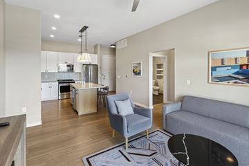 Scottsdale apartment for rent - A modern kitchen with a dining area and a living room.