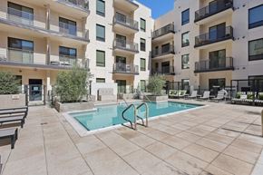 Scottsdale apartment for rent - A pool surrounded by apartment buildings.