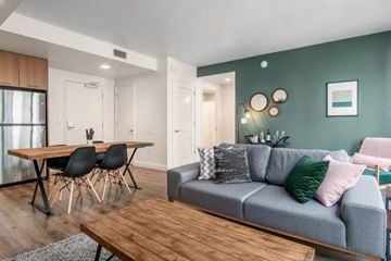 San Francisco apartment for rent - A modern living room with a grey couch and a wooden table.