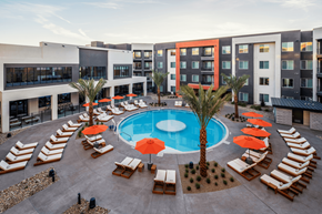 Las Vegas apartment for rent - A pool surrounded by sun loungers and umbrellas.