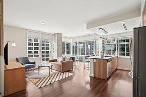 Denver apartment for rent - A modern kitchen and living room with a large window.