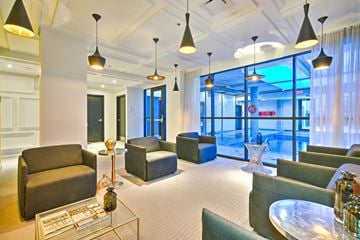 Montreal apartment for rent - A living room with a glass coffee table and a sofa.