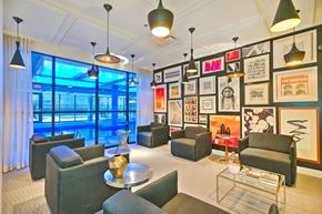 Montreal apartment for rent - A living room with a large window and a pool outside.
