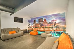 Montreal apartment for rent - A living room with a grey couch and orange pillows.