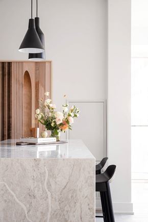 Toronto apartment for rent - a kitchen with a marble counter top and a vase of flowers