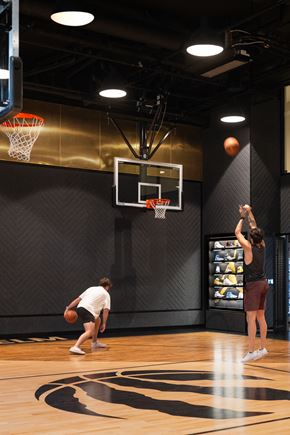 Toronto apartment for rent - two people playing basketball in a gym with a ball