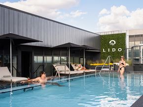 Toronto apartment for rent - a group of people in a swimming pool in front of a building