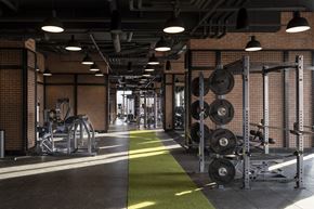 North York apartment for rent - A gym with a green floor mat and weightlifting equipment.