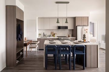 Toronto apartment for rent - A modern kitchen with a dining table and chairs.