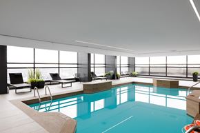 Montréal apartment for rent - A large indoor swimming pool with a sunken seating area.
