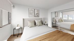 Montréal apartment for rent - A bedroom with a large bed and a window with blinds.