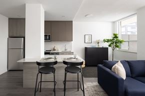 Toronto apartment for rent - A modern kitchen with a dining table and chairs.