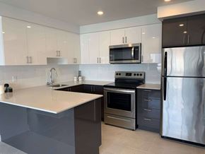 Montréal apartment for rent - a kitchen with stainless steel appliances and white counter tops
