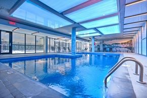 Montreal apartment for rent - a swimming pool in the middle of a building with glass walls