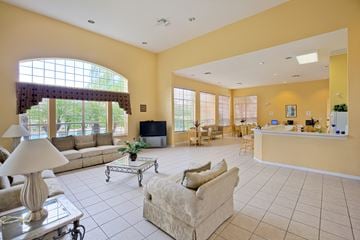 Naples apartment for rent - a living room with couches and a bar and a kitchen
