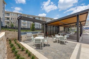 Veranda with lounge seating, kitchenette, & outdoor billiards table