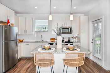 Chef-inspired kitchens with stainless-steel appliances, granite countertops & tile backsplash