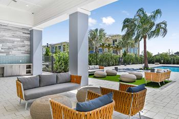 Covered veranda with lounge seating, communal table and summer kitchen