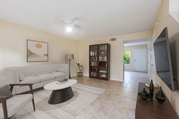 Gainesville apartment for rent - a living room with a white couch and a coffee table