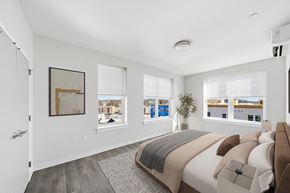 Norwalk apartment for rent - A bedroom with a large bed and a view of the city.
