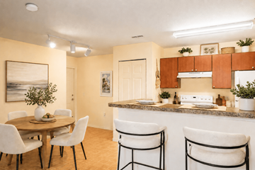 Largo apartment for rent - A kitchen with a table and chairs in the foreground and a painting on the wall.