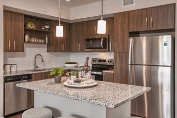 Chef-inspired kitchens with stainless-steel appliances, granite countertops & tile backsplash