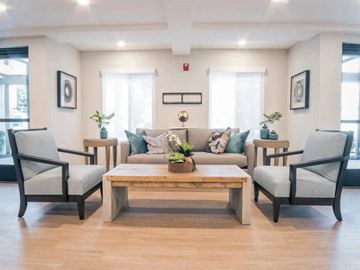 Carson apartment for rent - a living room with a couch and chairs and a table