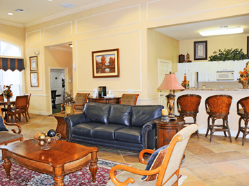 Tampa apartment for rent - A living room with a blue couch and wooden furniture.
