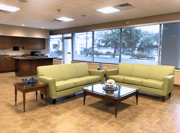 Norwalk apartment for rent - A living room with a yellow couch and a coffee table.