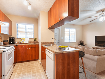 Titusville apartment for rent - A kitchen with wooden cabinets and a white stove top oven.
