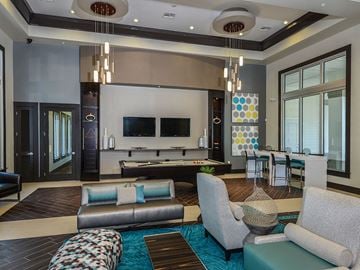 Pinellas Park apartment for rent - A modern living room with a pool table and a television.
