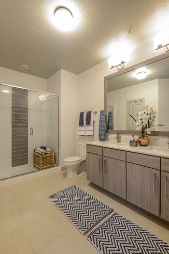 Bathrooms featuring granite or quartz countertops & glass showers or soaking tubs