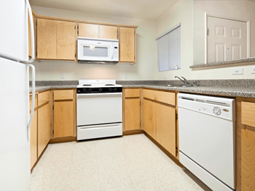 Lindsay apartment for rent - A kitchen with a white fridge, microwave, dishwasher and oven.