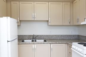 Oxnard apartment for rent - Kitchens with Granite Countertops at Sycamore Senior Affordable Apartments in Oxnard CA