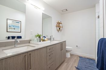 Primary bathrooms with double sink vanities in select apartments