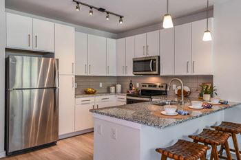 Chef-inspired kitchens with energy-efficient, stainless steel appliances and granite countertops