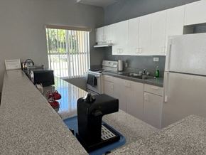 Labelle apartment for rent - a kitchen with a white refrigerator freezer next to a stove top oven