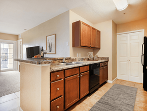 Zephyrhills apartment for rent - A kitchen with brown cabinets and a granite countertop.