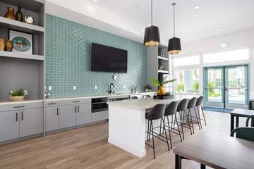 Merced apartment for rent - A modern kitchen with a white island and grey cabinets.