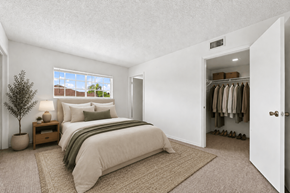 Homestead apartment for rent - A bedroom with a bed, nightstand, and a window.