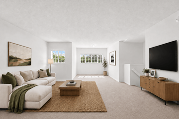 Homestead apartment for rent - A living room with a white couch, a brown rug, and a painting on the wall.