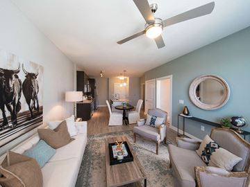 Dallas apartment for rent - a living room with furniture and a ceiling fan
