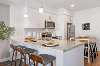 Expansive kitchen island or bar with pendant lighting & usb outlets