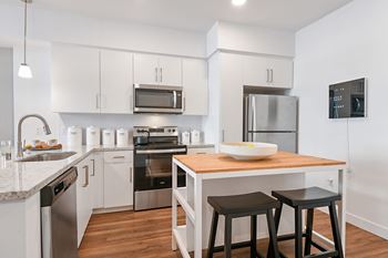 Chef-inspired kitchens with stainless-steel appliances, granite countertops & tile backsplash