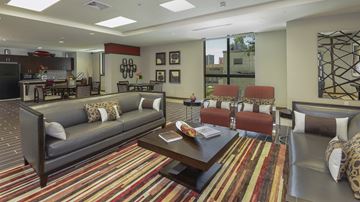 Miami apartment for rent - a living room with couches and chairs and a table